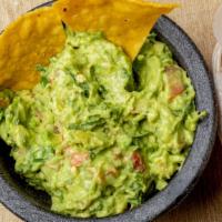 Guacamole Al Molcajete · Fresh guacamole made with avocado, tomatoes, onions, cilantro and fresh jalapeño. Served wit...