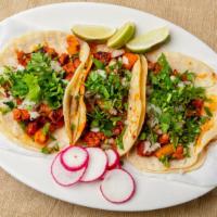 Al Pastor Taco · Marinated roast pork. Served with cilantro and onion.