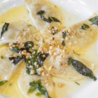 Butternut Squash Ravioli · Served with sage, walnuts, Parmegiano-Reggiano cheese and butter sauce.
