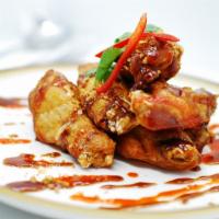 Chicken Wings · With tamarind chili sauce.