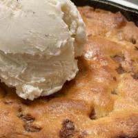 Skillet Chocolate Chip Cookie · Warm chocolate chip cookie baked in a small skillet, served with a scoop of ice cream. *Made...