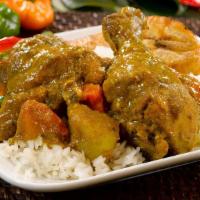 Curry Chicken · Tender chunks of curry-clad chicken cooked to the bone. Served with Rice & Peas or White Ric...