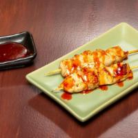 Satay Chicken · Grilled chicken skewers marinated  with spices, and drizzled with Malaysian chilly sauce.