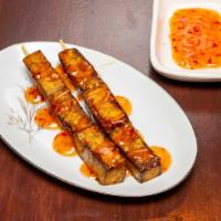 Tofu Skewer · Firm tofu skewers marinated  with spices, and drizzled with Malaysian chilly sauce.