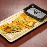 Scallion Pancake · Flaky green onion pancake; served with a side of soy sauce.
