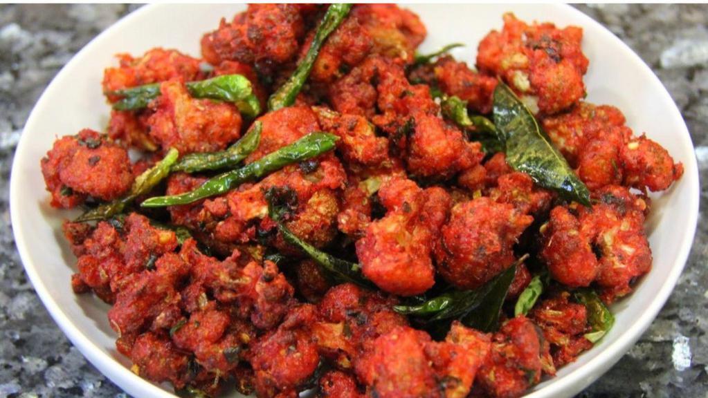 Gobi 65 · Cauliflower roasted in spicy sauce with whole red chilies and curry leaves.