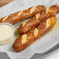 Bavarian Pretzels · 3 baked sticks with a choice of cheddar or Buffalo cheese sauce.