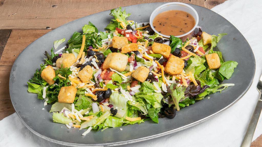 Greek Chicken Salad · Grilled chicken atop mixed greens, black olives, tomatoes, green onions, and croutons with a feta cheese vinaigrette.