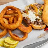 Philly Cheese Steak Sandwich · Grilled and sliced sirloin topped with mozzarella cheese, sauteed peppers, and onions. Serve...