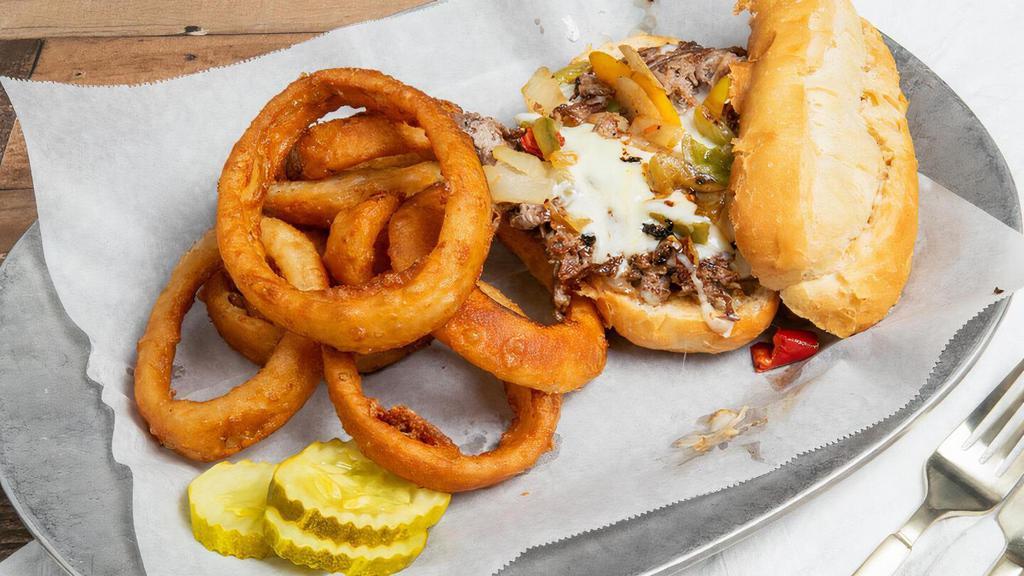 Philly Cheese Steak Sandwich · Grilled and sliced sirloin topped with mozzarella cheese, sauteed peppers, and onions. Served on an authentic Omarosa roll.