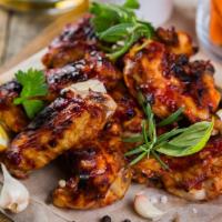 Jerk Chicken Wings · 5 pieces of Jerk Chicken wings served with house blue cheese ranch, pickled carrots and cele...