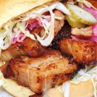 Pork Chashuu Sando Meal · Slow braised chashuu with black garlic sauce and pickles on a Martin's potato roll with a si...