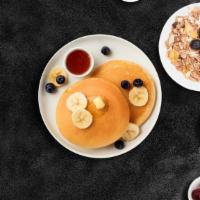 Banana Berry Pancakes · Fluffy banana and berries pancakes cooked with care and love served with butter and maple sy...