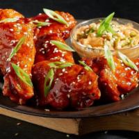 Spicy Asian Bbq Wings · Crispy Wings, tossed in Spicy Asian BBQ Sauce, with a side of our House Made Spicy Asian Slaw