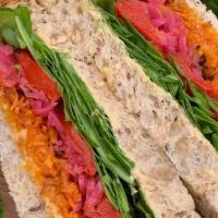 Rainbow Sandwich · harissa carrots, hummus, pickled cabbage, roasted red peppers, arugula on kneaded bread ligh...