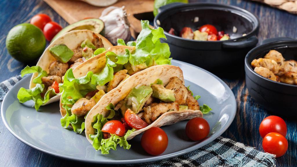 Chicken Tacos · Fresh grilled juicy chicken topped with crisp lettuce, diced fresh tomatoes, our house cilantro sour cream, red onions, sweet cubed mangoes and a refreshing drizzle of our cajun cream sauce.