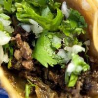 Carne Asada Taco · Grilled marinated New York strip steak. Choice of Mexican-style (topped with cilantro and on...