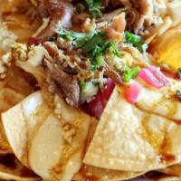 Carnitas Nachos · Homemade Mexican style 8 hours slow-cooked pork shoulder.