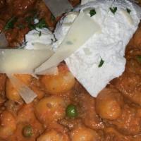 Gnocchi Alla Maria · Pink bolognese sauce, with peas and caramelized onions, topped with ricotta.
