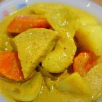 Yellow Curry · Yellow curry paste cooked in coconut milk with onions, potatoes, carrots and string beans.