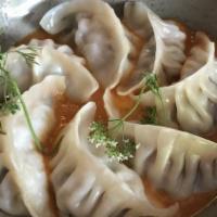 Momo · Vegetarian. Tibetan steamed dumpling with tomato fenugreek sauce.