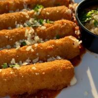 Mozzarella Sticks · and-breaded sticks, fried golden brown and served with our homemade marinara dipping sauce. ...