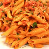 Penne Alla Vodka · Made with Italian plum tomatoes, vodka, cream and Romano cheese with sliced onion, garlic an...