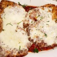 Chicken Parmigiana · Large chicken cutlets breaded in homemade bread crumbs over homemade tomato sauce topped wit...