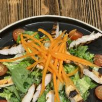 Grilled Chicken Salad · Mixed greens, tomatoes, and carrot topped with grilled chicken breast in lemon dressing.