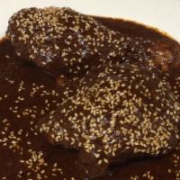 Of Mole Poblano · A leg and a thigh in mole sauce served with an order of five corn tortillas.