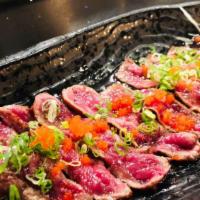 Beef Tataki · sliced seared beef with shichimi pepper, top with masago green onion, ponzu sayce