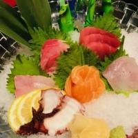 Sashimi Deluxe* · 7 varieties of thin slices of raw fish with radish and seaweed.