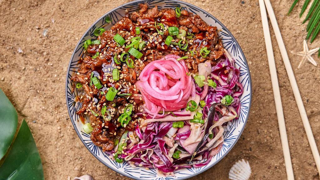 Bulgogi Ribeye Rice Bowl · Thinly sliced soy marinated beef over cucumbers, cabbage slaw, and your choice of base and salad
