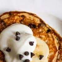 Banana Chocolate Chip Pancakes · Pancakes with chocolate chips baked inside and topped with fresh bananas.