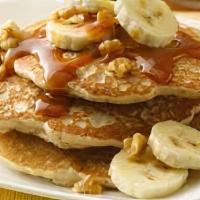 Pancakes With Peanut Butter And Walnuts · Topped with creamy peanut butter and garnished with walnuts.