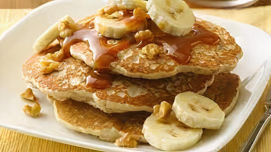Pancakes With Peanut Butter And Walnuts · Topped with creamy peanut butter and garnished with walnuts.