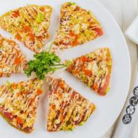 Tuna Pizza · Fresh slices of tuna, avocado, tempura crunch masago, scallion, wasabi dressing, and spicy m...