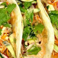 Vietnamese Pork Tacos · Grilled pork in flour tortillas with cucumber, pickled radish & carrot, jalapeno pepper, min...