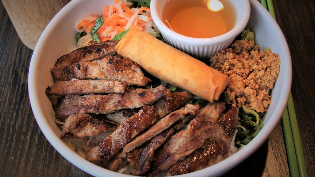 Noodles With Pork & Eggroll Bowl · Vermicelli rice noodles with grilled pork and Vietnamese egg roll served with a bed of shredded lettuce, mint, cilantro, bean sprouts, marinated julienne radishes and carrots, crushed dry-roasted peanuts and Vietnamese sweet and sour sauce.