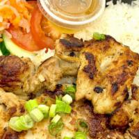 Grilled Chicken With Rice · Marinated grilled chicken with rice, lettuce, tomatoes, and cucumbers, and julienne radish a...