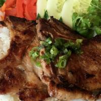 Porkchops With Rice · Marinated grilled pork chops with rice, lettuce, tomatoes, and cucumbers, and julienne radis...