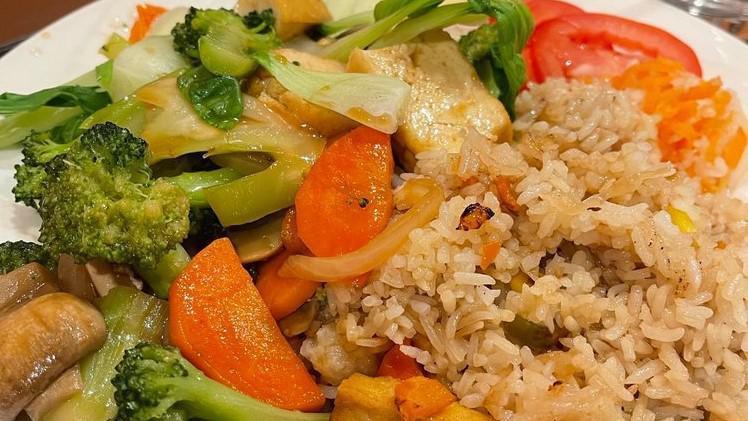 Tofu & Vegetables With Rice · Vegetable rice plate. Sautéed tofu, mushrooms, bok choy, broccoli, carrots, onions, crushed peanuts, and a vegetarian egg roll. Garnished with lettuce and sliced tomatoes and cucumbers. Served with a choice of white or brown rice.