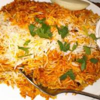 Chicken Biryani · Tender pieces of chicken cooked with basmati rice in a rich curry sauce with fruits and nuts