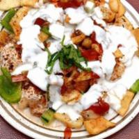 Chaat Papri · Fried lentil chips served under freshly made channa chaat and yogurt.
