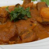 Goat Vindaloo · Extra hot spiced goat cooked in a sharp, tangy sauce.
