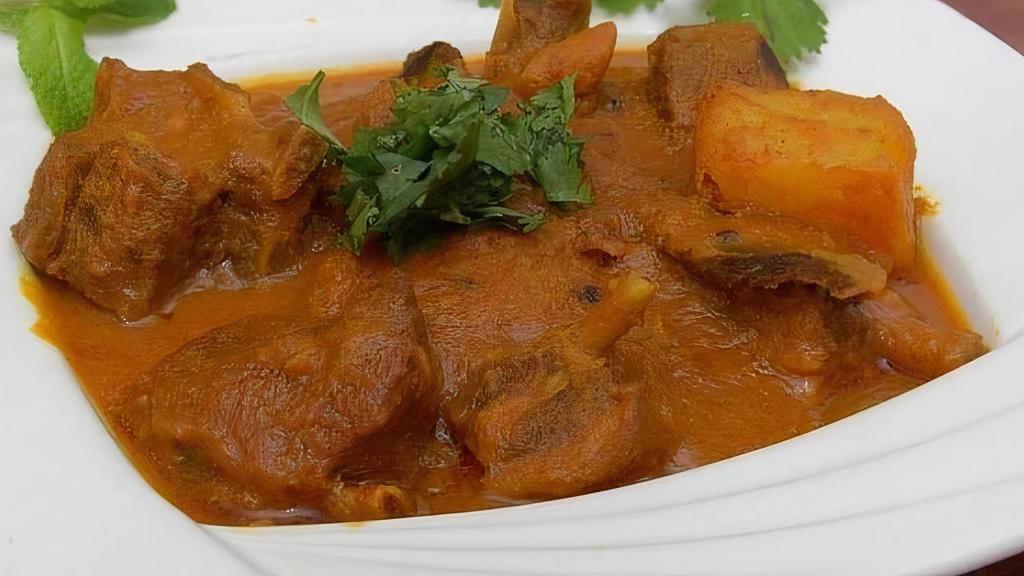 Goat Vindaloo · Extra hot spiced goat cooked in a sharp, tangy sauce.