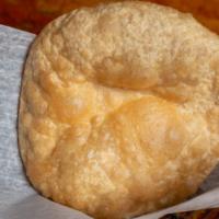 Puri · Deep fried whole wheat puffed light bread.