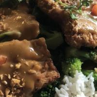 Chicken Pra Ram · Marinated white meat chicken served with broccoli, topped with ground peanuts, and roasted p...