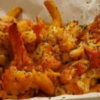 Lobster Loaded Fries · Seasoned fries drizzled in a cheesy sauce covered in chunks of Maine lobster.