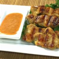 Satay · Soy sauce, gluten, wheat. Strips of grilled marinated chicken on bamboo skewers / peanut sau...